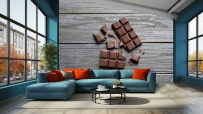 Tasty chocolate on wooden background, flat lay Wall mural