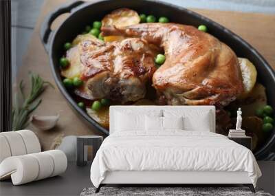 Tasty cooked rabbit with vegetables in baking dish on table, closeup Wall mural