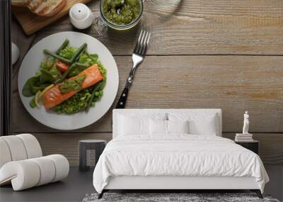 Tasty cooked salmon with pesto sauce served on wooden table, flat lay. Space for text Wall mural