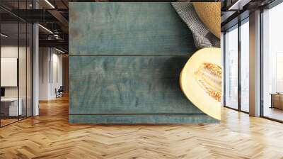 Tasty cut ripe melon on blue wooden table, flat lay. Space for text Wall mural