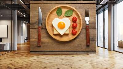 Tasty fried egg in shape of heart with toast served on wooden table, flat lay Wall mural