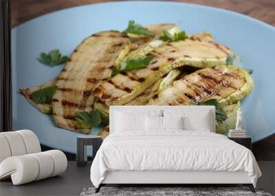 Tasty grilled courgette slices with parsley on wooden table, closeup Wall mural