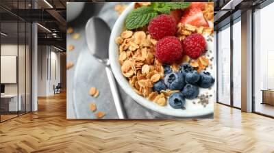 Tasty homemade granola with yogurt and berries on grey table, closeup. Healthy breakfast Wall mural