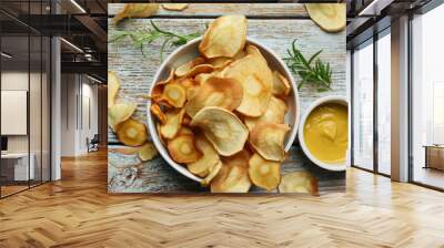 Tasty homemade parsnip chips with sauce and rosemary on old light blue wooden table, flat lay Wall mural