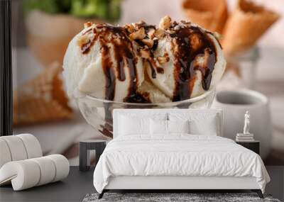 Tasty ice cream with chocolate topping and nuts in glass dessert bowl on table, closeup Wall mural