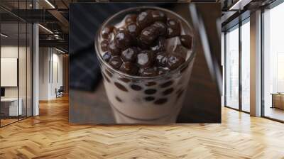 Tasty milk bubble tea in glass on brown table, closeup Wall mural