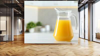 Tasty orange juice in jug on white marble table. Space for text Wall mural