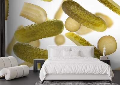 Tasty pickled cucumbers falling on white background Wall mural