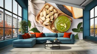 Tasty pistachio cream and nuts served on white table, flat lay Wall mural