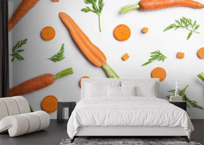 Tasty ripe carrots and leaves isolated on white, top view Wall mural