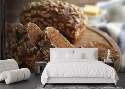 Tasty rye bread on wooden board, closeup Wall mural