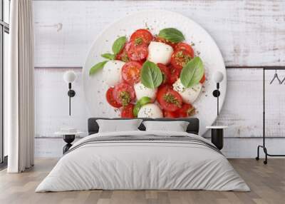 Tasty salad Caprese with tomatoes, mozzarella balls and basil on white wooden table, top view Wall mural