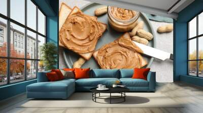 Tasty sandwiches with peanut butter and nuts on grey textured table, flat lay Wall mural