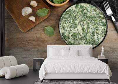 Tasty spinach dip on wooden table, flat lay Wall mural