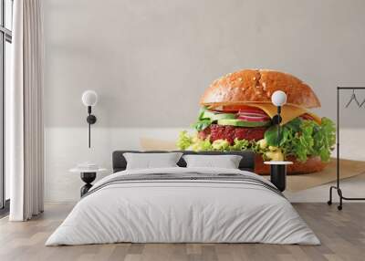 Tasty vegetarian burger with beet cutlet on table against light background. Space for text Wall mural