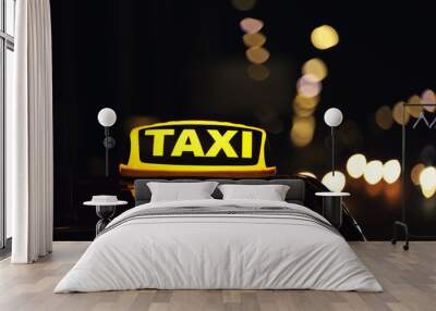 Taxi car with yellow roof sign on city street at night, closeup Wall mural