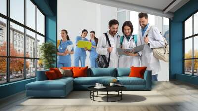 Team of medical students in college hallway, space for text Wall mural