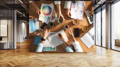 Team of professional designers working together at table, top view Wall mural