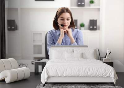 Teenager in headset having video chat via laptop at home. Remote work Wall mural