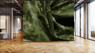 Texture of crumpled camouflage fabric as background, top view Wall mural