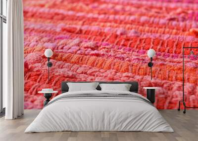 Texture of knitted orange and pink fabric as background, closeup Wall mural