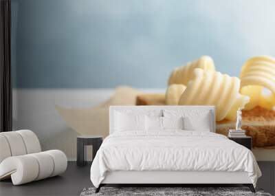 Toasted bread with fresh butter curls on table, closeup Wall mural