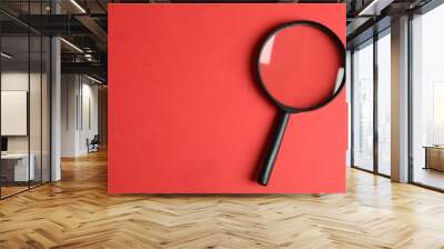 Top view of magnifying glass on red background, space for text. Search concept Wall mural