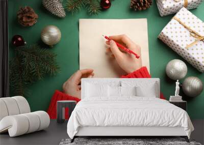 Top view of woman writing letter to Santa at green table, closeup Wall mural