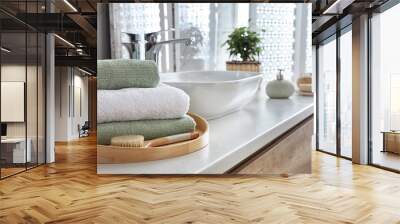 Towels and brush on table in bathroom. Space for text Wall mural