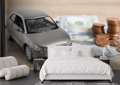 Toy car and money on table. Vehicle insurance Wall mural