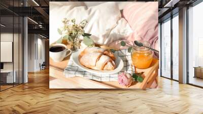 Tray with delicious croissants, cup of coffee and honey on bed Wall mural