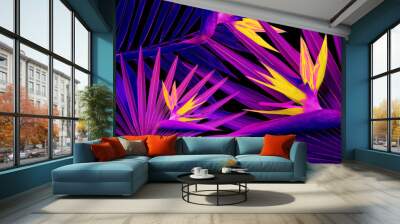 Tropical leaves and flowers in neon colors on black background Wall mural