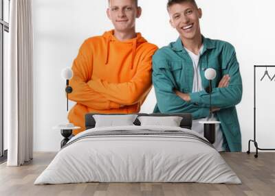 Two happy brothers posing with crossed arms on white background Wall mural