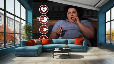 Virtual icons demonstrating different health problems and overweight woman eating sweets in living room Wall mural