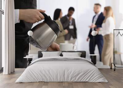 waitress pouring hot drink during coffee break, closeup Wall mural