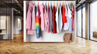 Wardrobe with stylish girl's clothes hanging on rack Wall mural