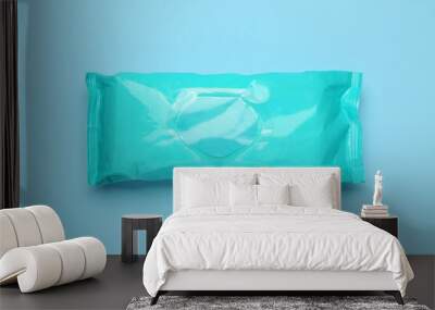 Wet wipes flow pack on light blue background, top view Wall mural