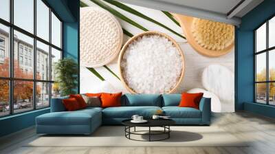 White sea salt and supplies for spa scrubbing procedure on wooden table, flat lay Wall mural