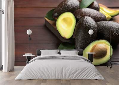 Whole and cut avocados on wooden table. Space for text Wall mural