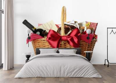 Wicker basket full of gifts isolated on white Wall mural