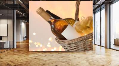 Wicker basket with bottles of wine against blurred background, closeup Wall mural