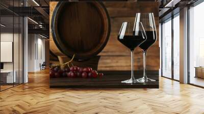 Winemaking. Tasty wine, barrel and ripe grapes on wooden table Wall mural