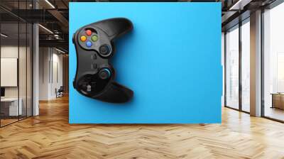 Wireless game controller on light blue background, top view. Space for text Wall mural