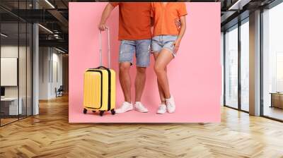 Woman and man with suitcase on pink background, closeup Wall mural