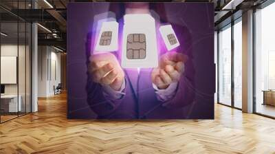 woman demonstrating sim cards of different sizes on color background, closeup Wall mural