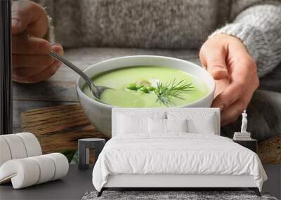 Woman eating fresh vegetable detox soup made of green peas at table, closeup Wall mural