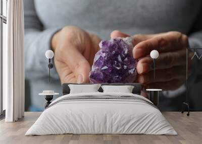 Woman holding beautiful violet amethyst gemstone, closeup Wall mural