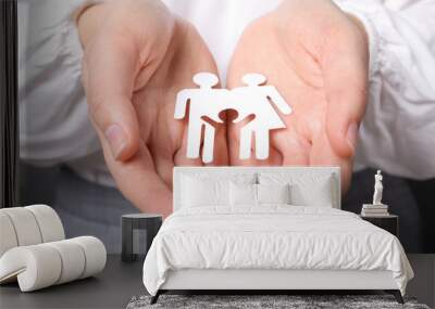 Woman holding cutout paper family, closeup. Life insurance concept Wall mural