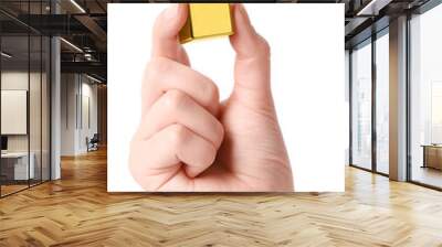 Woman holding gold bar on white background, closeup Wall mural