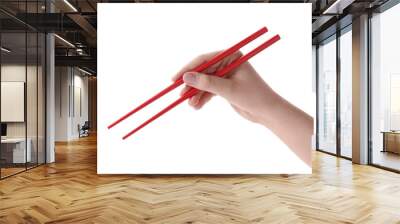 Woman holding pair of red chopsticks on white background, closeup Wall mural